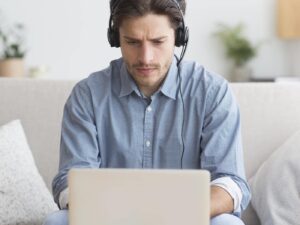 serious-student-in-headphones-studying-at-laptop-a-Z8PFWB5.jpg