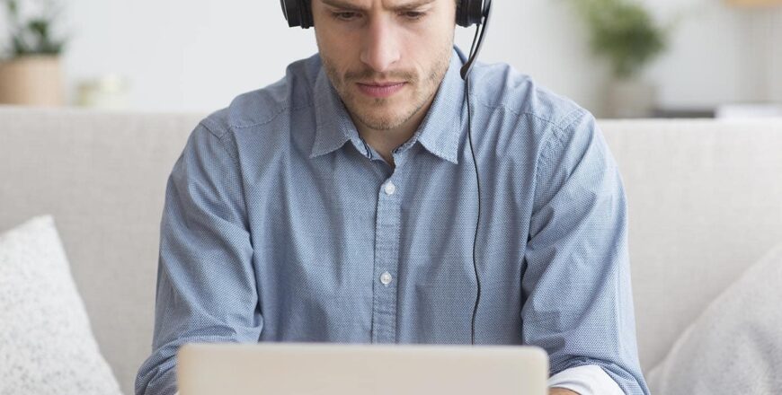 serious-student-in-headphones-studying-at-laptop-a-Z8PFWB5.jpg