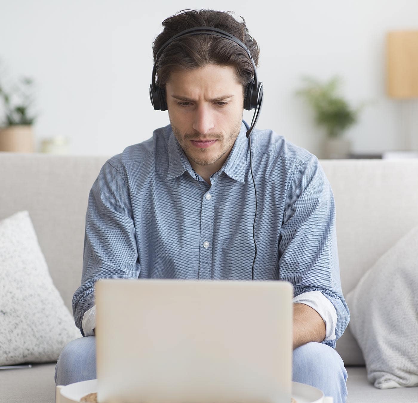 serious-student-in-headphones-studying-at-laptop-a-Z8PFWB5.jpg